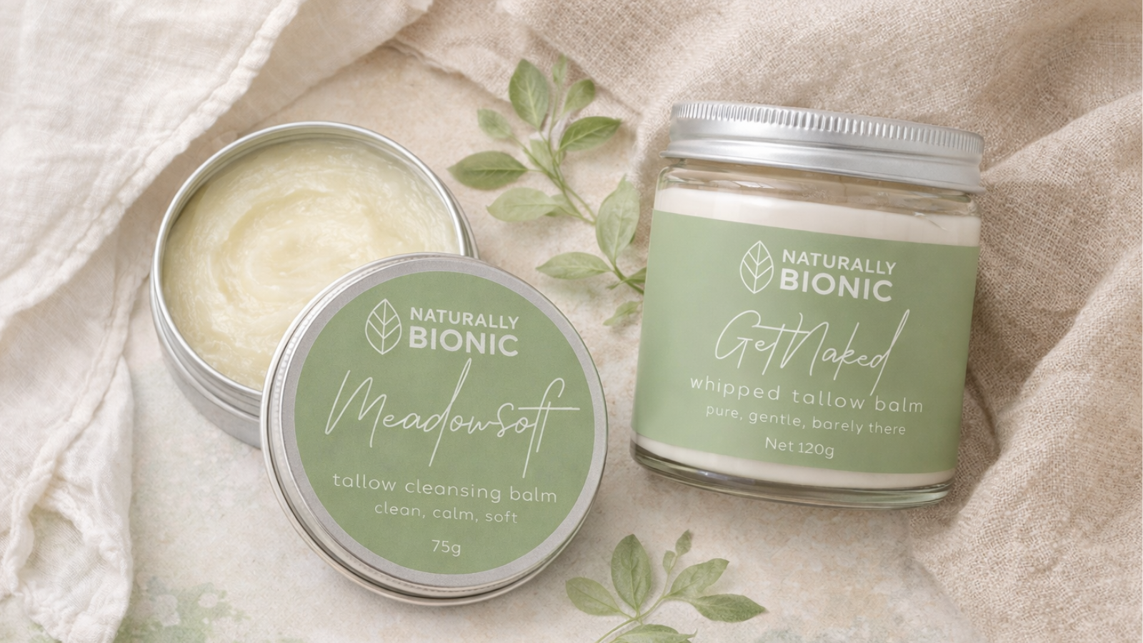 Three tins of Naturally Bionic balm on a textured fabric background
